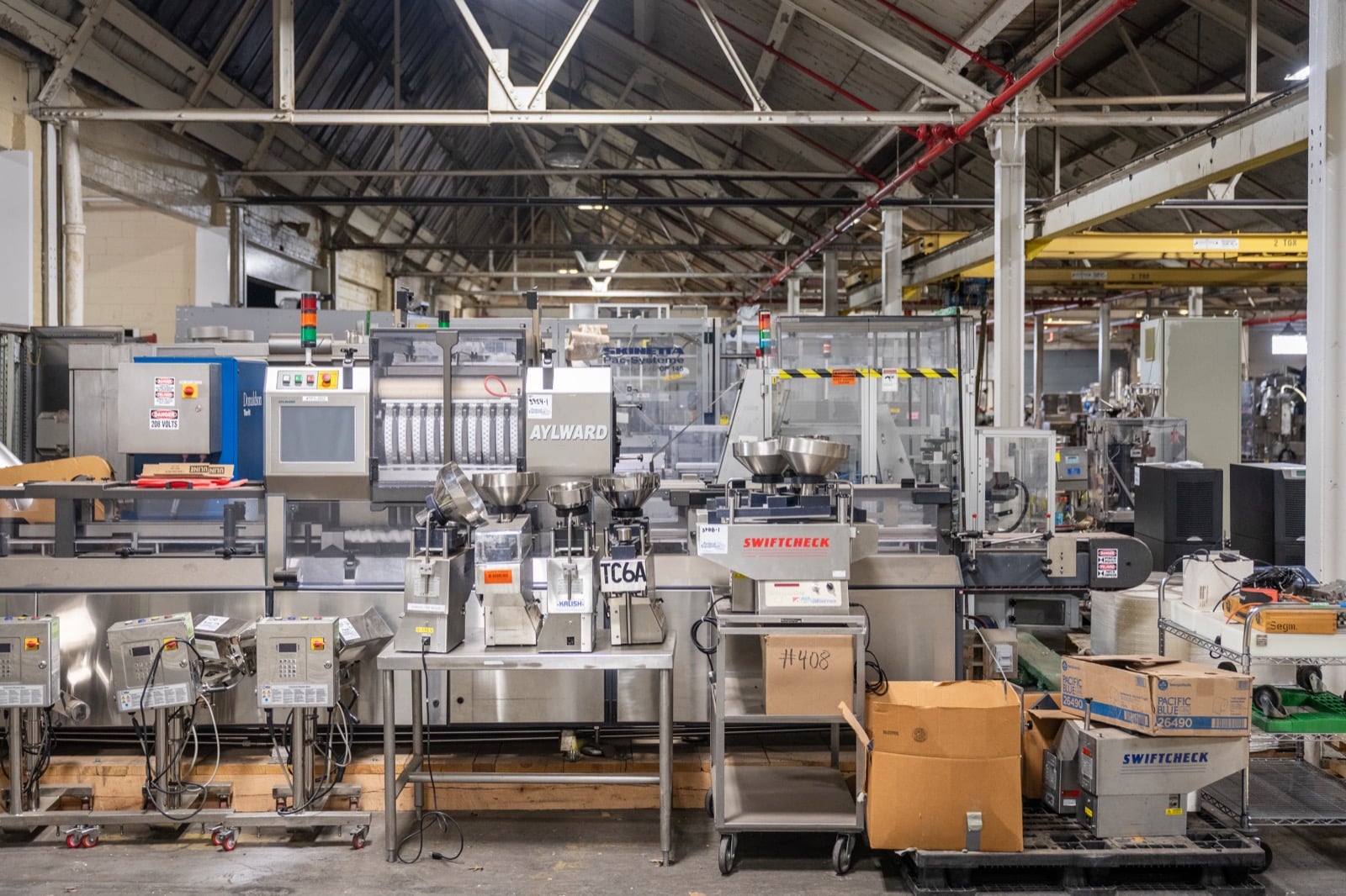 Aylward, Kalish, and Swiftcheck tablet and capsule counting equipment on the Federal Equipment Company warehouse floor in Cleveland, OH